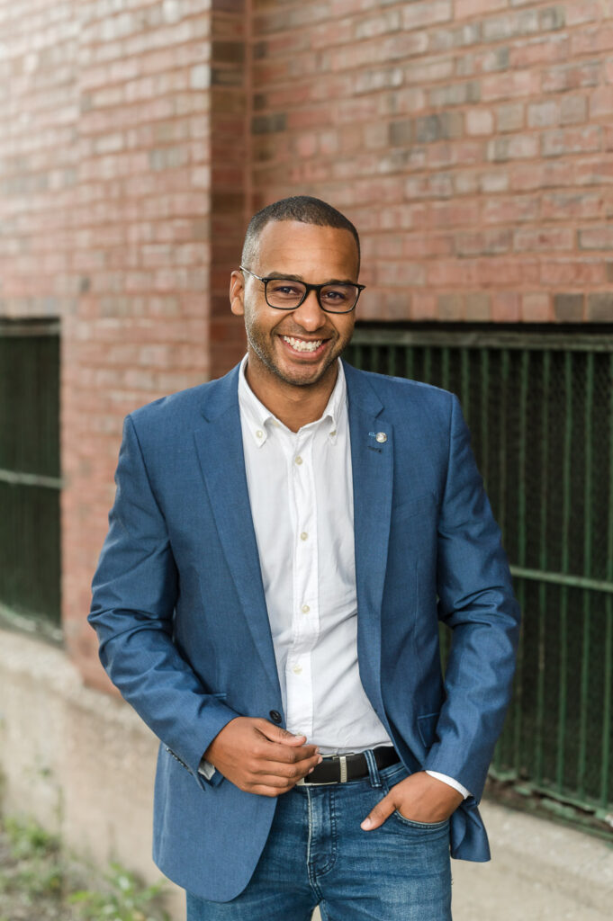 Man poses with one hand in his pocket during a headshot photography session