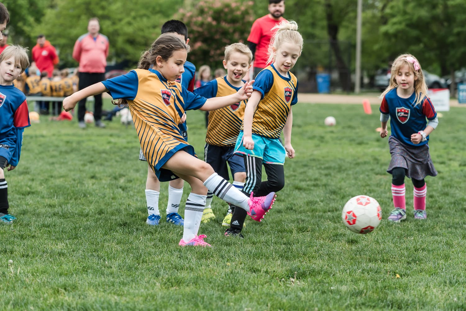 Six year old girl kids soccer ball during a kids soccer game on Chicago's Northside