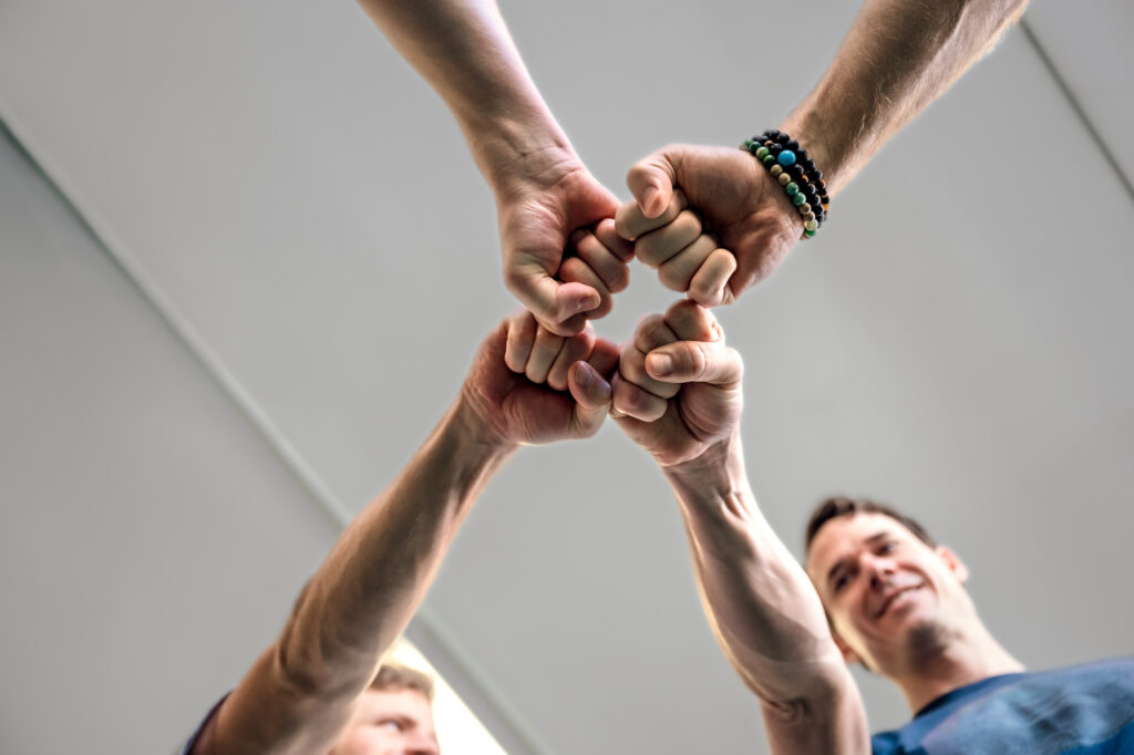 four way fist bump after a personal training session - created for custom stock photography for Finding Fitness