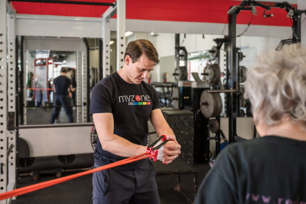 David Burnett demonstrating resistance bands to a client