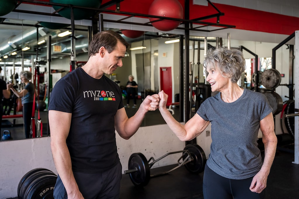 David Burnett and client give a fist bump after a workout