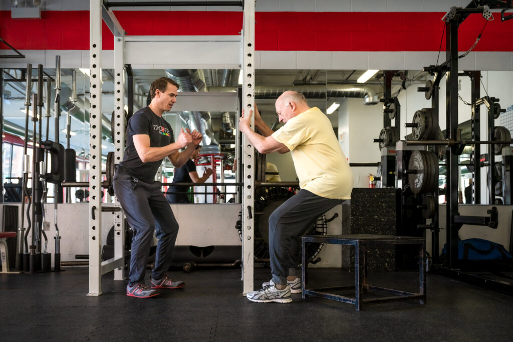 David Burnett working with a client on squats