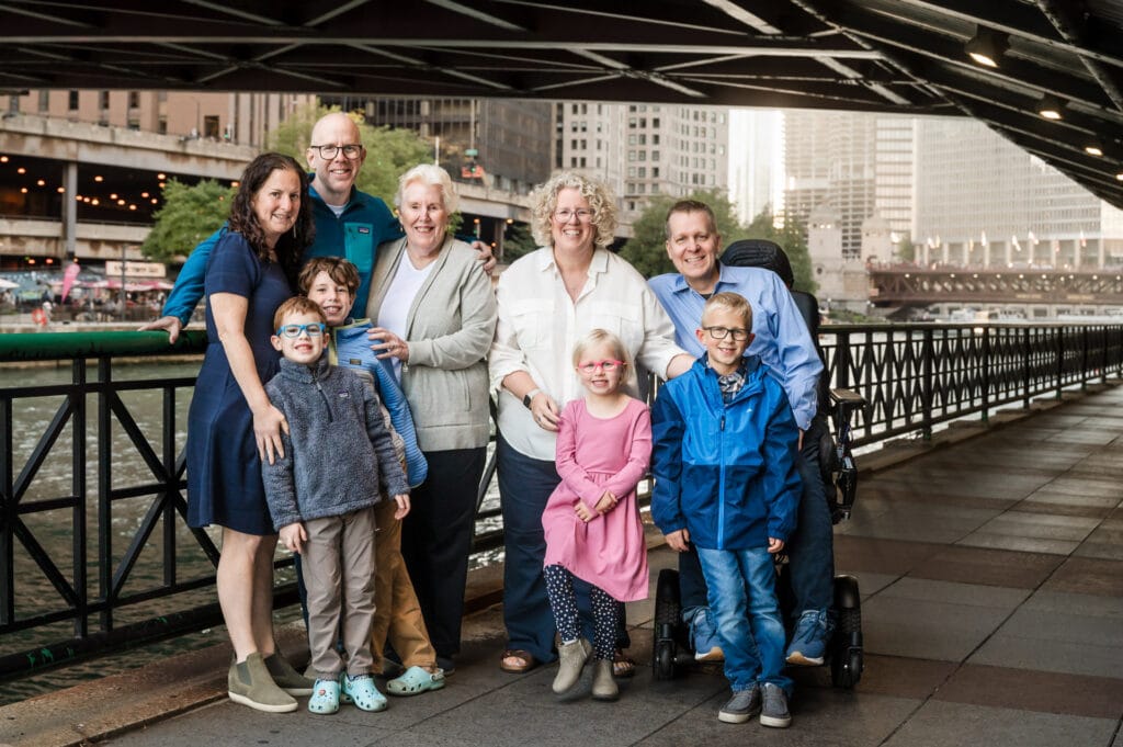 Extended family photos with the Grandpa, the 2 adult siblings with each of their families and kids along the Chicago Riverwalk during the late summer.