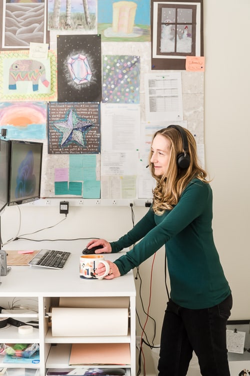 Woman at stand-up desk while talking with a client over a FaceTime meeting