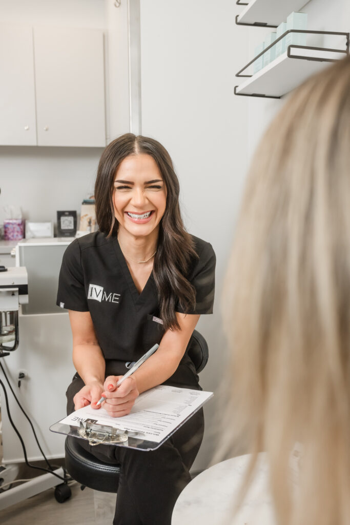 Aesthetician laughs during a client consult