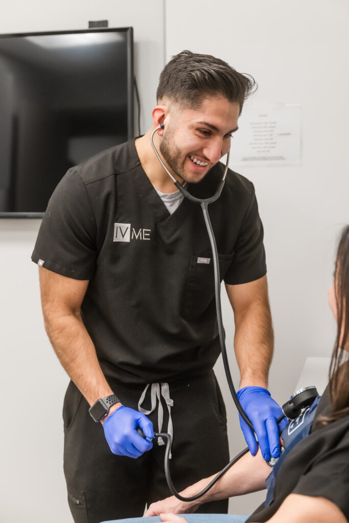 Client being prepped with blood pressure taken prior to hydration therapy at IVME Wellness + Aesthetics