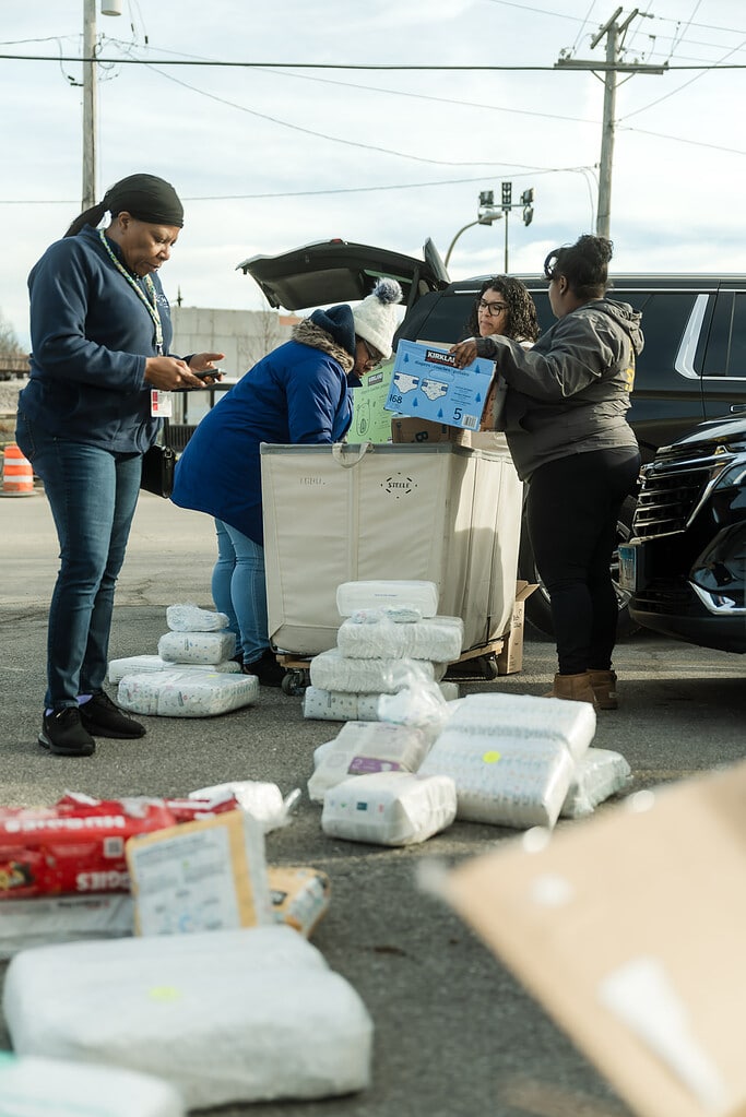 Social workers sort diapers for their clients with young children at a diaper distribution event