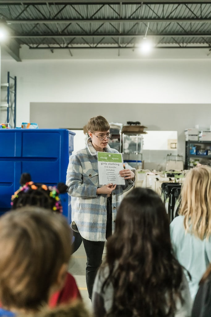 Volunteers learn how to organize and pack the donations according to Share Our Spare's method