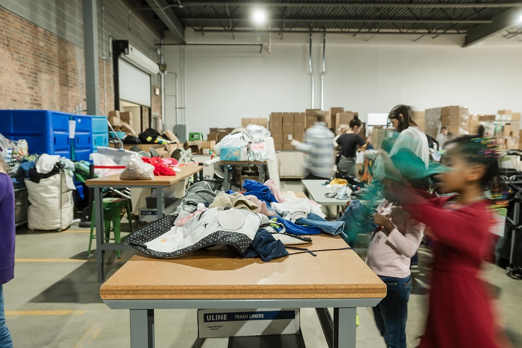 Volunteers sort the donations to be packed into bundles for families in need in Chicago