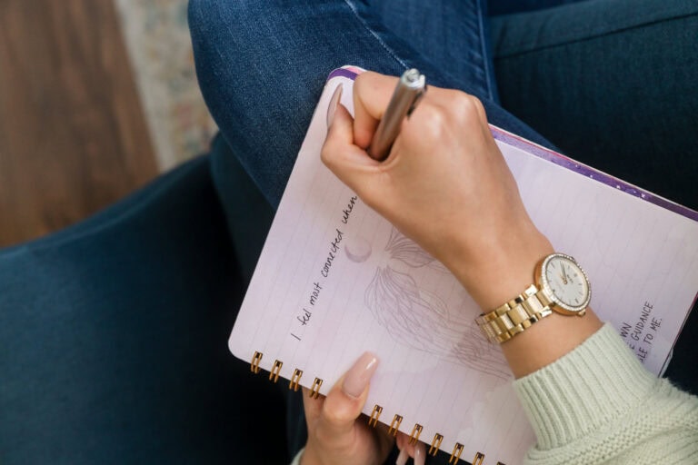 Woman's hand writing in a journal