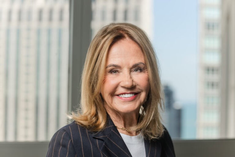 Headshot of female lawyer in front of window with Chicago background