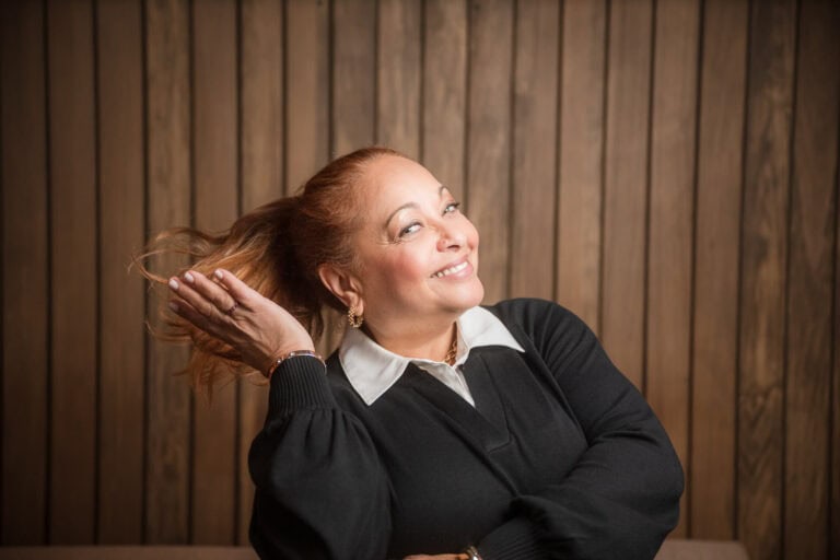 Camille Obrochta of @properties - a personality-filled headshot of her flicking her hair